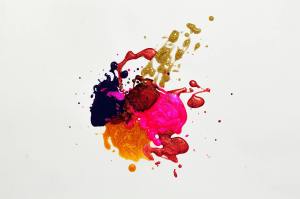 yellow, black, pink, and red paint on a white background